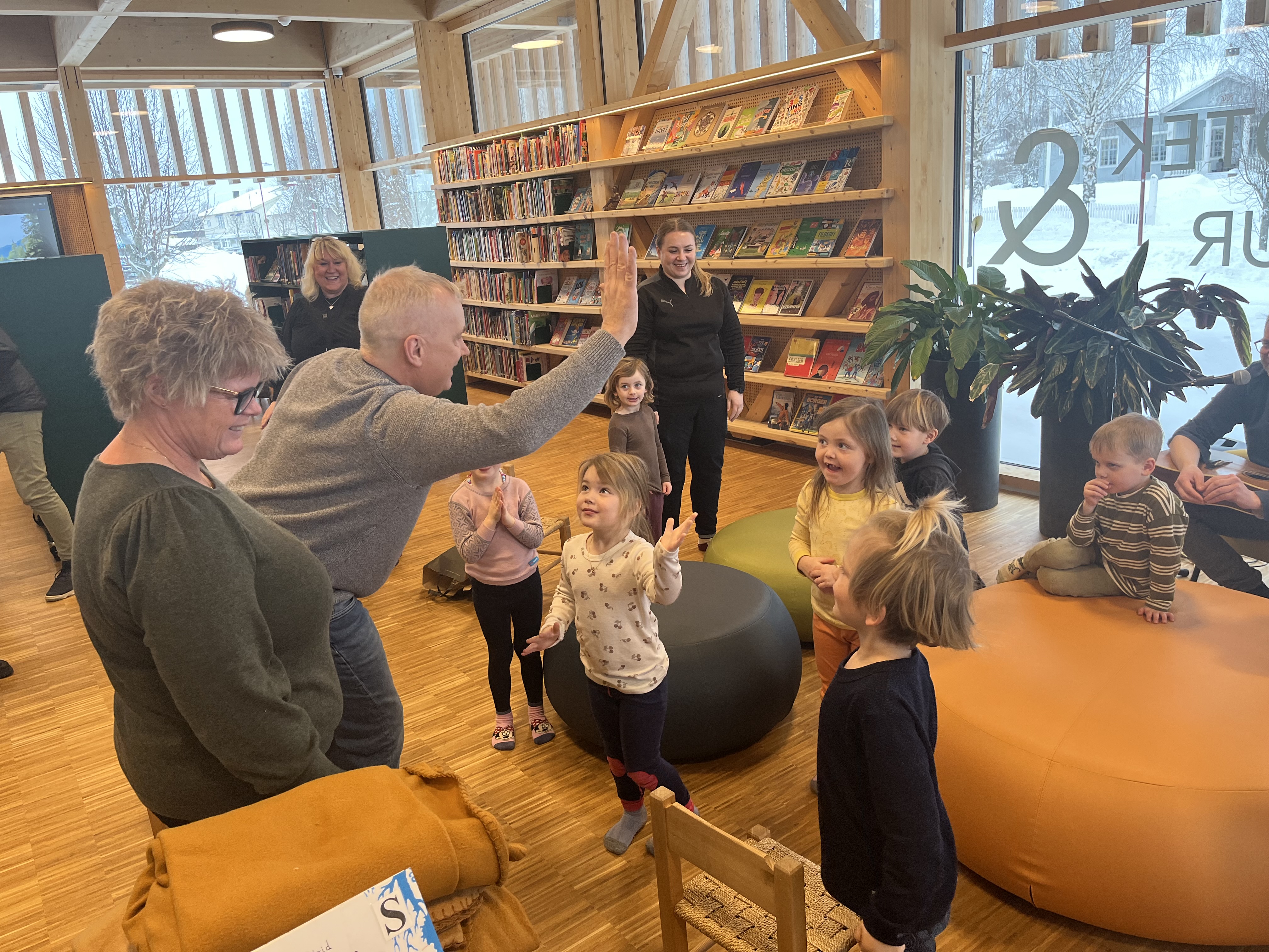 En "highfive" fra Knut Storberget til de minste på kulturskolen. Foto: Aslak Nordstoga Lilleland. Mann hilser på barn
